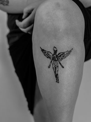 Experience the iconic album cover in stunning blackwork style by the talented artist Oliver Soames. Embrace the essence of Nirvana in a unique and illustrative tattoo design.