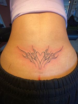 Get a unique tribal twist on a classic heart design with this neotribal tramp stamp by artist Beth Farbrother.