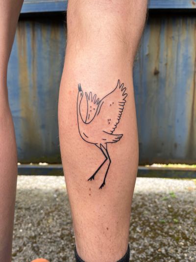 A stunning blackwork tattoo of a majestic crane designed by artist Dave Norman, embodying grace and elegance.