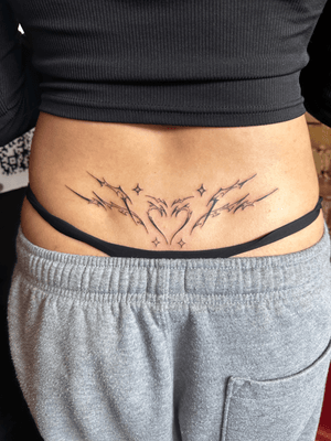 Lower back tribal/cyber heart and sparkle design! 