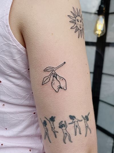 A hand-poked blackwork tattoo by Laura featuring a lemon tree branch with fruit, intricately detailed in fine lines.