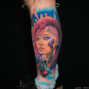 A realistic and colorful tattoo of a cyberpunk woman, created in a vibrant watercolor style by artist Marie Terry.