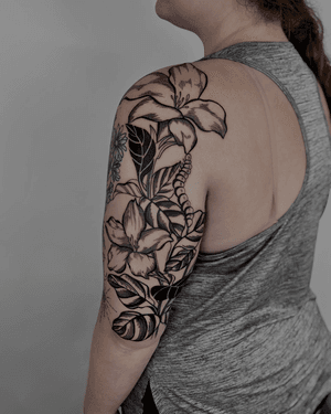 Blackwork etching tattoo of a beautiful botanical flower designed by Alona Hamova.