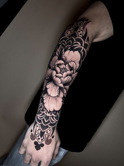 Illustrative dotwork tattoo featuring a detailed peony flower pattern, expertly done by artist Hamid.