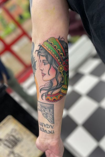 A captivating neo-traditional tattoo of a native woman, beautifully illustrated by Cara Hayward with traditional elements.