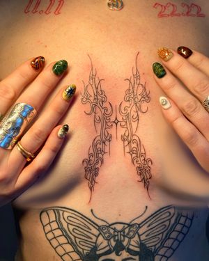 Get a futuristic twist on a classic motif with this fine line neotribal butterfly tattoo, designed by renowned artist Beth Farbrother.