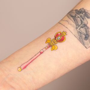 Capture the magic with Mika Tattoos' rendition of Sailor Moon's wand in stunning anime style. Perfect for any fan of the iconic series.