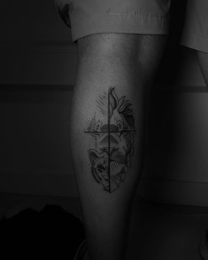 Fine line blackwork tattoo of lion and lion cub within geometric cross design, by artist Ruby Rowland.