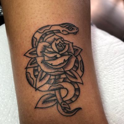 Beautiful traditional tattoo featuring a snake and rose motif by Marc 'Cappi' Caplen. Perfect blend of nature and mystique.