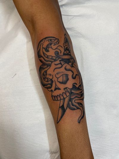 Get inked by Marc 'Cappi' Caplen with a stunning traditional tattoo featuring a snake and skull motif.