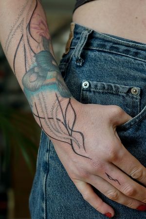 Experience the intricate beauty of organic motifs in this stunning dotwork tattoo by Mona Noir Tattoo.