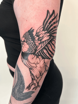 A stunning black and gray bird tattoo in dotwork and illustrative style, created by Jack Howard.