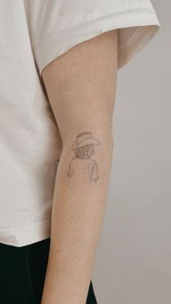 Small cowboy girl with a cowboy hat on the forearm