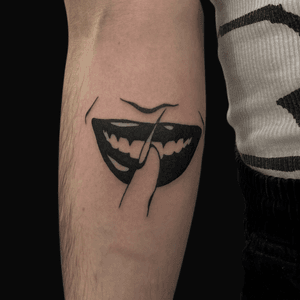 Blackwork tattoo of shushing gesture, smiling lips. Artist: Connor Howerton.