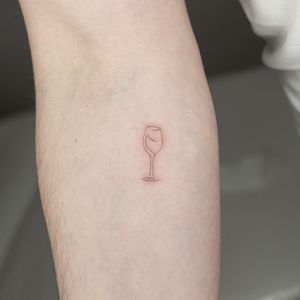 Elegant fine line tattoo featuring minimal and delicate glass motif, created by the talented Mika Tattoos.