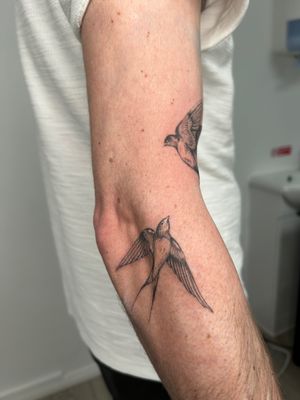 Capture the beauty of flight with this intricately detailed black and gray swallow tattoo by acclaimed artist Ellie Shearer.