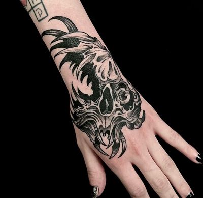 Embrace darkness with this blackwork skull tattoo by artist Ker Kusterbeck. An illustrative piece inspired by horror.