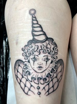 Beautiful black and gray tattoo of a clown pierrot done by Amandine Canata, capturing the essence of melancholy and whimsy.