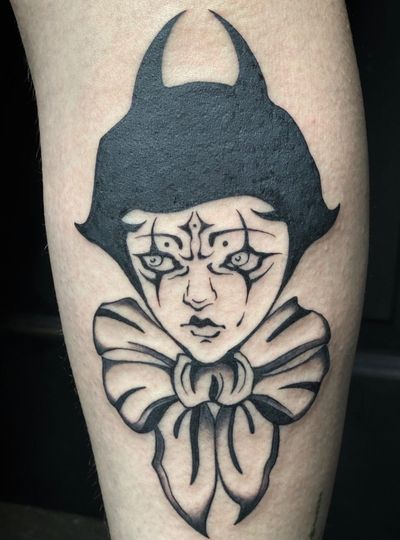 Blackwork illustrative tattoo featuring a devil, clown, and pierrot by Amandine Canata.