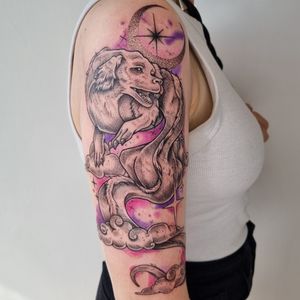 Dotwork and watercolor style tattoo featuring clouds, moon, stars, the neverending story, Falkor, and sparkle elements by Belle Tannahill.