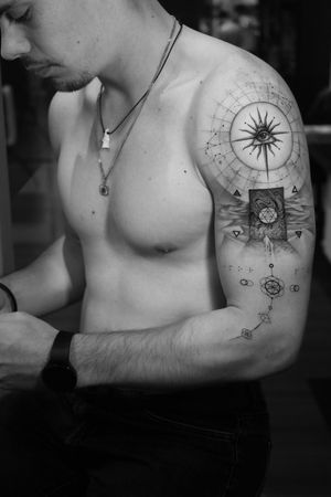 This black and gray fine line tattoo features a geometric sun surrounded by constellations, symbolizing the bond of family and the universe. By artist Light Grays.