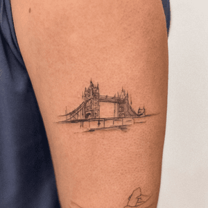 A fine-line illustrative tattoo of London Tower, created by artist Alex Caldeira, with intricate details and sketch-like style.