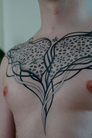 Unique ornamental design by Mona Noir Tattoo, combining blackwork and dotwork techniques for a flowing organic motif.