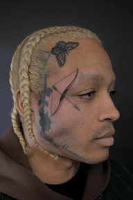 Face tattoo bow and arrow