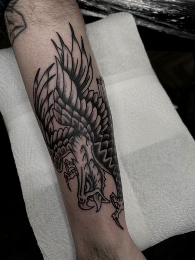 A black and gray traditional style tattoo of an eagle by artist Barney Coles.