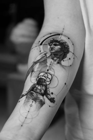Get lost in space with this stunning black and gray micro-realism tattoo of a astronaut inspired by Greek mythology.
