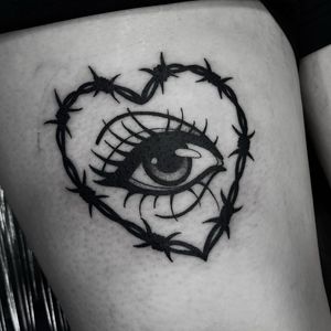 Illustrative tattoo of a heart surrounded by thorns and an eye, done by Barbara Nobody.