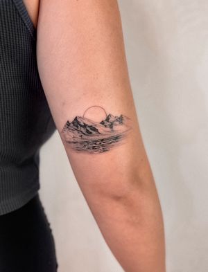 Incredible black and gray micro realism tattoo by artist Alex Caldeira. Depicts a stunning sunset over mountains and a serene lake landscape.