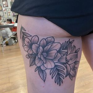 A stunning black and gray tattoo of a delicate flower, expertly done by Lawrence Canham. Perfect for lovers of intricate floral designs.