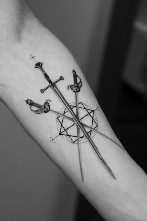 This black and gray sword tattoo by Light Grays combines fine line and geometric elements for a unique and intricate design.