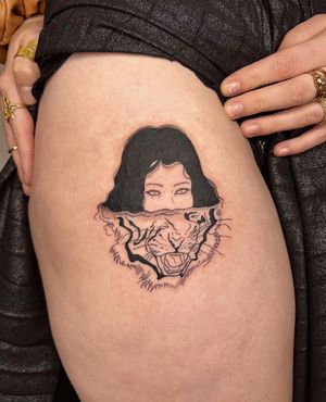 A mesmerizing blackwork tattoo by Alessia Lo Piccolo featuring a tiger and a woman in a reflection, symbolizing self image.