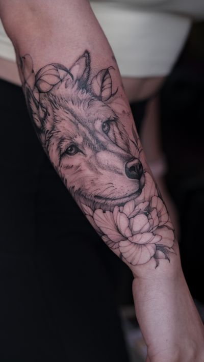 Get a captivating black and gray wolf tattoo by talented artist Maria with incredible attention to detail.