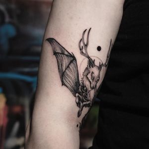 Abstract black and gray illustrative tattoo featuring a fox with antlers, wings, and a touch of horror. By Sasha Davydova.