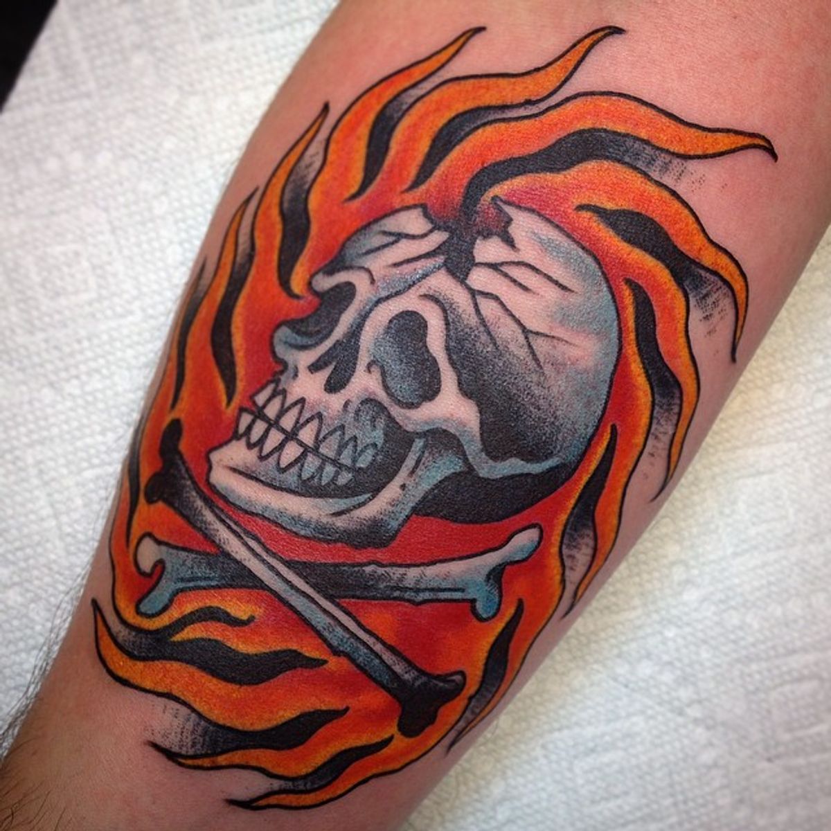 flaming skull and crossbones tattoo