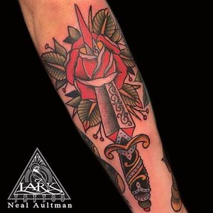 Traditional style rose and dagger tattoo by Lark Tattoo artist Neal Aultman #traditional #traditionaltattoo #traditionaltattoos #dagger #rose 