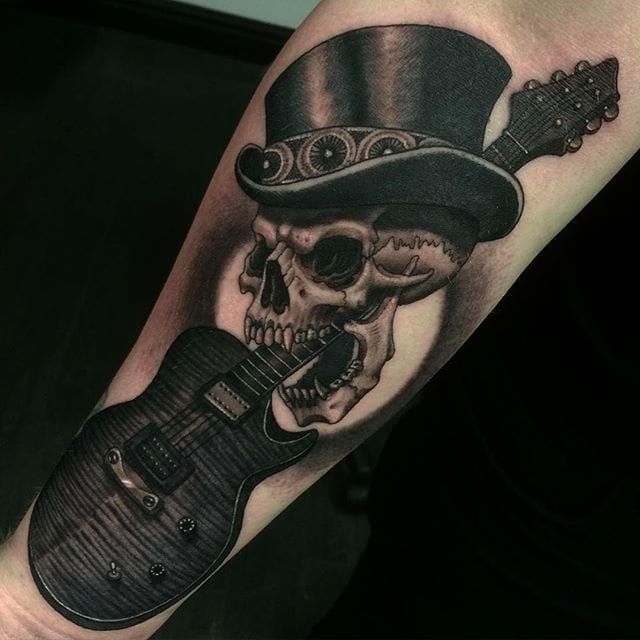New School Skull Biting A Guitar Tattoo Idea  BlackInk