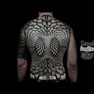 The geometric mirage created by this incredible back-piece by Ilya Cancad Kanaurov creates the illusion of multidimensionality. #backpiece #blackandgrey #geometric #IlyaCancadKanaurov  #opticalillusion #ornamental  #shading #stippling