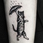 Kitty in the rain tattoo by Mike Adams #MikeAdams #cattattoos #blackwork #linework #dotwork #cat #petportrait #rain #umbrella #kitty #cute