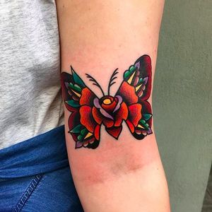 Awesome looking moth and rose tattoo by Chris Papadakis. #ChrisPapadakis #traditionaltattoo #moth #rose