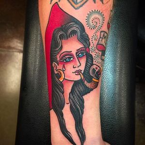 Smokin' red hooded woman tattoo done by Paul Nycz. #PaulNycz #traditional #neotraditionaltattoo #coloredtattoo #smokinglady #redridinghood #red #pipe #toke