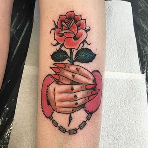 A pair of handcuffed hands holding a long-stemmed rose by Rachie Rhatklor (IG—rachierhatklor). #prisoneroflove #RachieRhatklor #rose #traditional