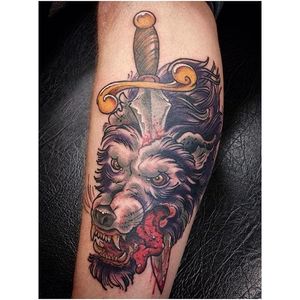 Stabbing  dagger tattoo by Greg Fischer #GregFischer #daggerthroughtattoo #stabbingdaggertattoo #wolf #blood #dagger