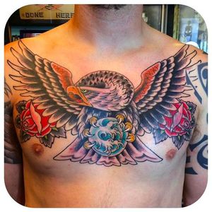 Clean and solid eagle chest tattoo by Jason Brooks. #JasonBrooks #GreatWaveTattoo #boldtattoos #TraditionalTattoo #eagle #roses