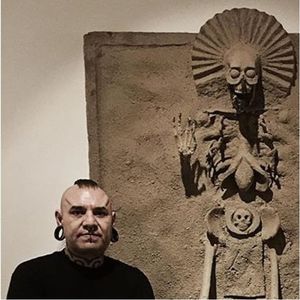 Photo of Goethe (IG—tattoosbygoethe) next to one of his replicas of ancient Aztec sculpture. #Aztec #death #fineart #Goethe #Underworld
