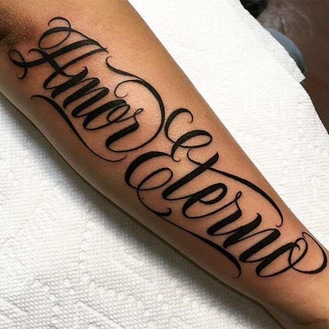 amor lettering tattoo on the upper back