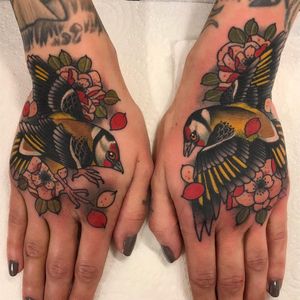 Bird hand tattoo by Matt Adamson #MattAdamson #birdtattoos #color #neotraditional #bird #feathers #wings #fly #cherryblossoms #floral #flower #leaves #nature